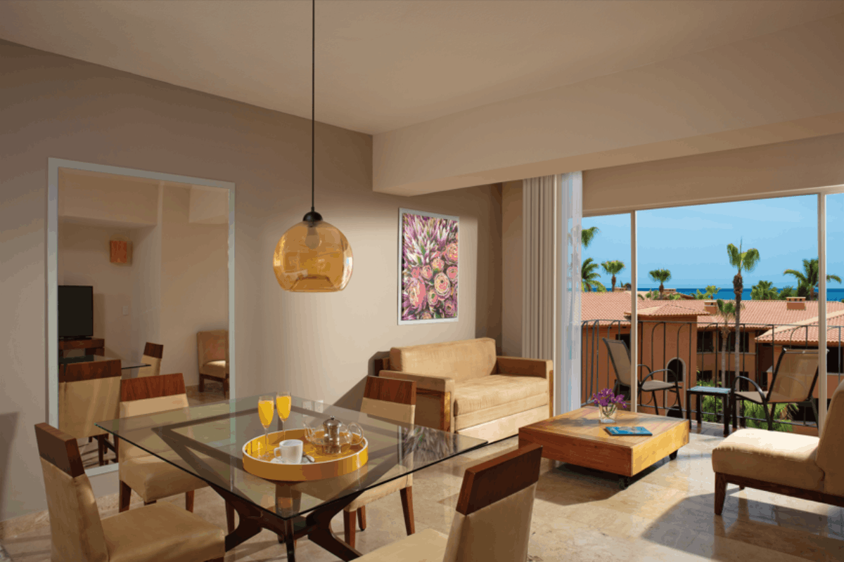 One Bedroom Suite at Krystal Grand Los Cabos with living room, dining area, balcony and spacious interiors.